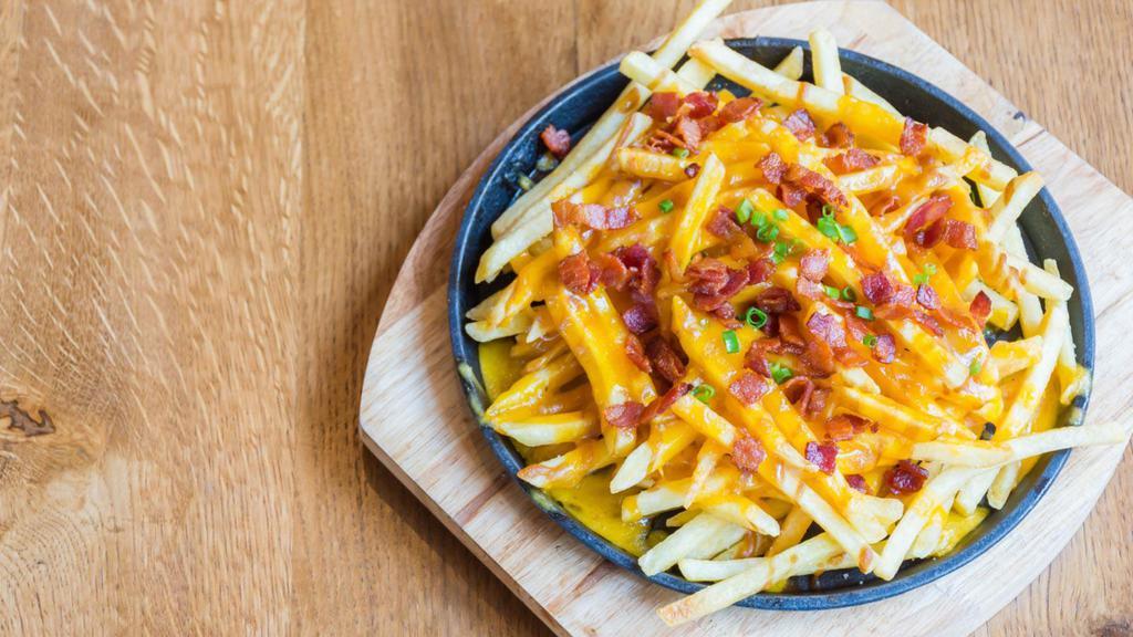 Cheese Fries With Bacon Bits · Crispy golden fresh French fries smothered in creamy cheese then topped with crispy bacon bits.