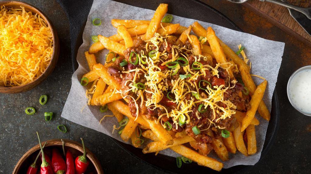 Chili Cheese Fries With Bacon Bits · Crispy golden fresh French fries smothered in creamy cheese and hearty house made chili and topped with crispy bacon bits.