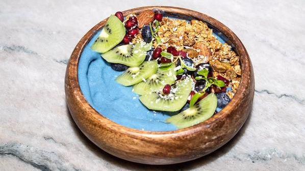 Blue Bowl · Banana pineapple coconut milk blue majik raw spirulina topped with kiwi blueberries strawberry and granola.