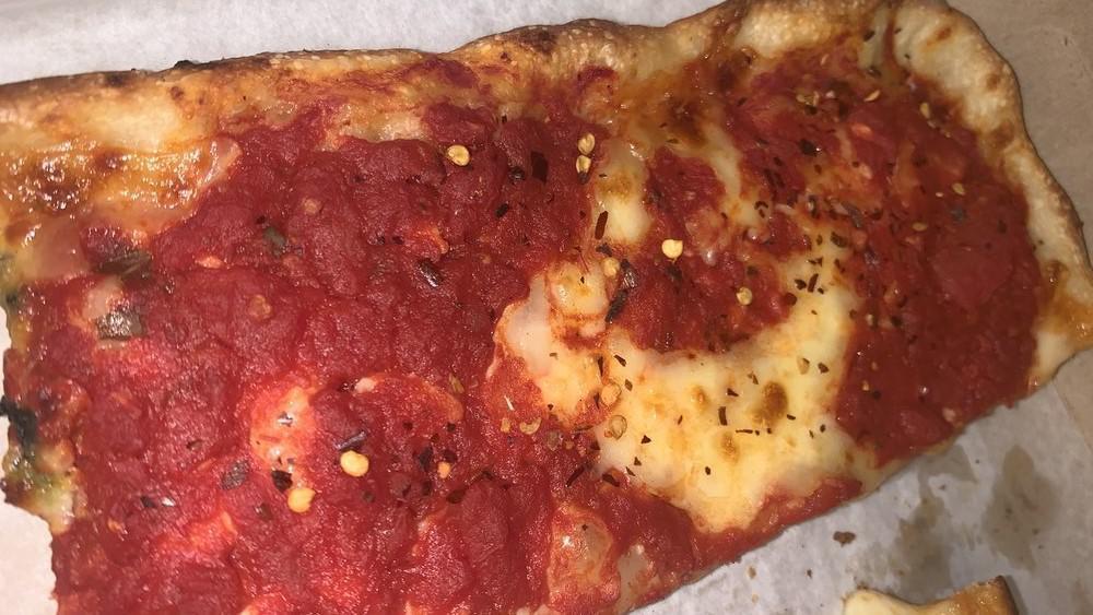 Grandma Pizza Slice · Thin Sicilian crust brushed with olive oil and garlic, fresh mozzarella, and spotted with chunky san marzano tomato sauce.