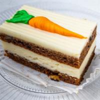 Carrot Cake Slice · Made with fresh walnuts, carrots, cinnamon, allspice, and topped with fresh cream cheese fro...