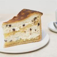 Sicilian Cheesecake Slice · Made with sweet creamy ricotta cheese, chocolate chips, and glazed cherries in a yellow spon...