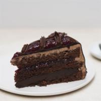 Chocolate Raspberry Truffle Slice · A chocolate sponge cake layered with rich dark chocolate and raspberry preserves with a hint...