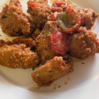Scarpariello Wings · Spicy chicken wings tossed in a white wine, oil and garlic sauce with cherry peppers.