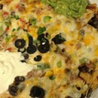Tex Mex Chill Nachos · Mucho melted cheese blend over hot nachos w/  jalapeño peppers and Amigo Chili, topped with ...