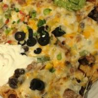 Doritos Nachos · Mucho melted cheese blend over hot nachos w/ black olives, scallions, pinto & black beans.  ...