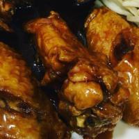 Teriyaki Wings · Marinated or glazed in a soy based sauce. cooked wing of a chicken coated in sauce or season...