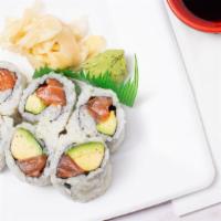 Salmon Avocado Roll · Salmon and avocado roll with rice on the outside.