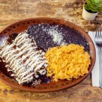 Enchiladas Oaxaqueñas · Stuffed with chicken breast and layered with mole sauce. Topped with cheese,  cream, onions ...