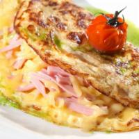 Ham Omelette · Delicious breakfast Omelette made with three eggs and ham. Served with a side of Toast and c...