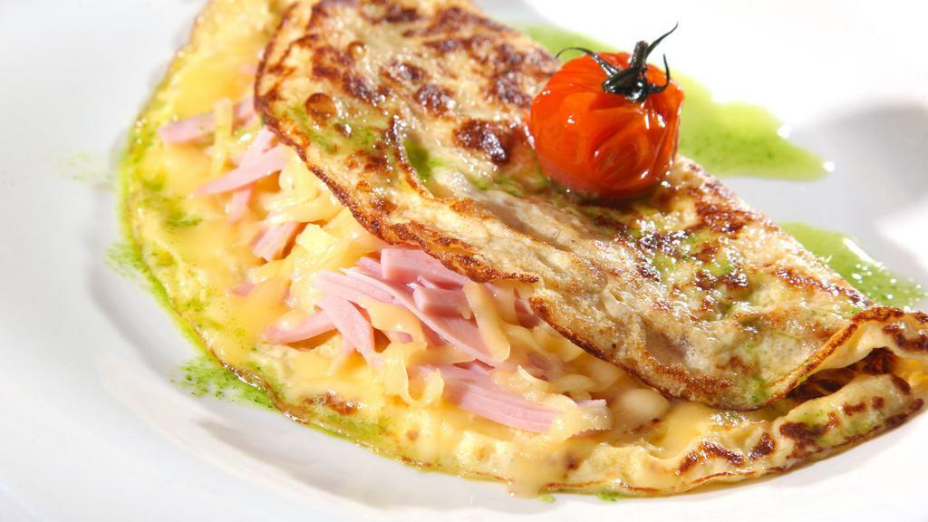 Ham Omelette · Delicious breakfast Omelette made with three eggs and ham. Served with a side of Toast and customer's choice of side dish.