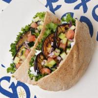 Grilled Eggplant Pita · Grilled eggplant with lettuce, tomatoes, cucumber, onions, and your choice of sauce wrapped ...