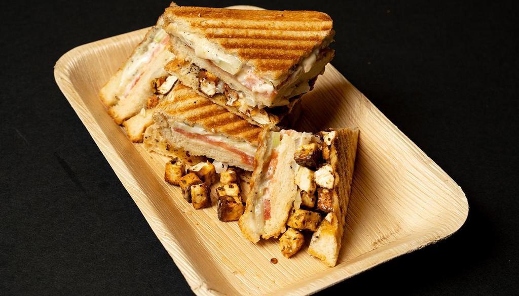 Paneer Toofani: · 2 layered grilled cheese sandwich with tabasco flavored tossed panner, crushed red pepper and oreganos with cucumber, onion and tomato