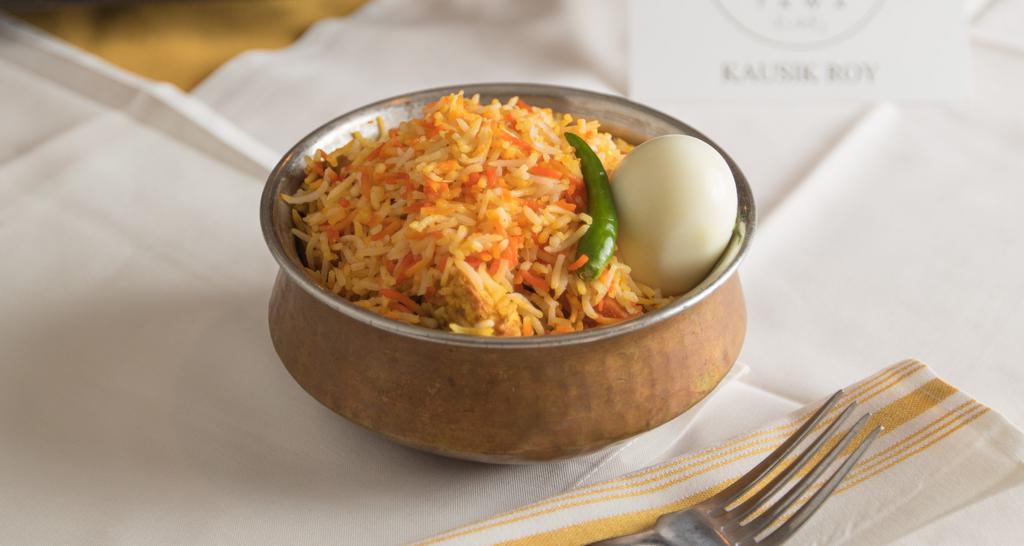 Egg Biryani · Dish of curried boiled eggs cooked traditionally with flavored basmati rice adding tawa herbs and spices.