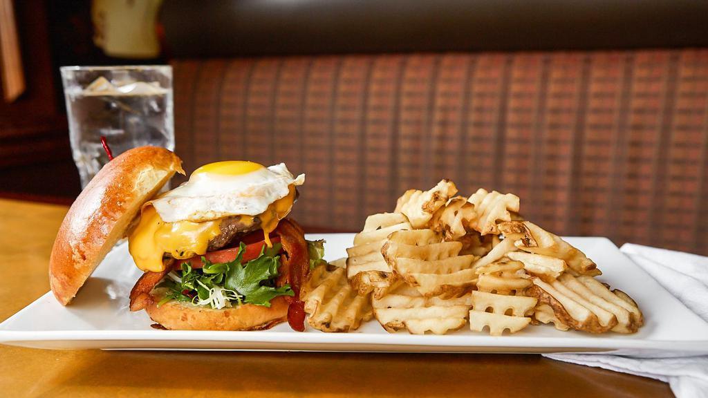 Down & Under Burger · Beef burger crowned with a fried egg, two strips of bacon, american cheese and mayo. Diner classic.