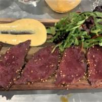 Elk Carpaccio · served with my mother Elize's homemade mustard and arugula salad.