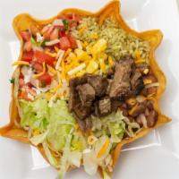 Grilled Steak Taco Salad · Taco salads come in a Taco Shell with Yellow rice or cilantro rice, black beans or pinto bea...