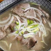 Wood & Herb Smoked Brisket Pho · Beef broth, house-smoked brisket, rice noodles, garnished with cilantro, scallion, onion. Gl...