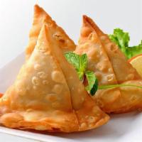 Samosa · Minced potatoes and peas wrapped in pastry dough and fried.