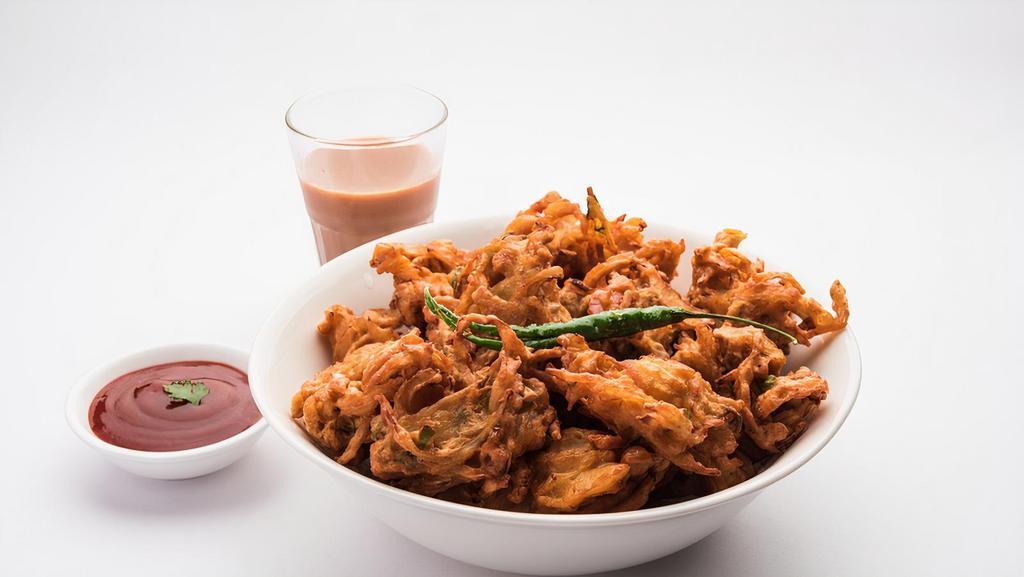 Onion Pakoda · Fresh cut onion dipped in chickpea batter and deep fried.