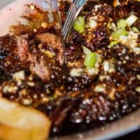 Marinated Steak Tidbits  · Marinated steak bits topped with Blue cheese crumbles and scallions, served with toasted gar...
