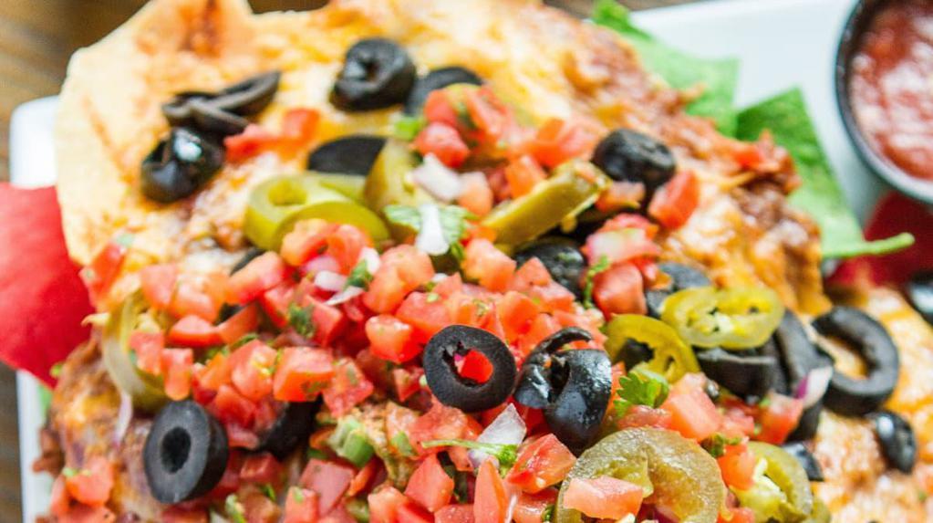 Nachos Locos · Nachos smothered with melted cheddar jack cheese, sliced jalapeños, sour cream, black olives, pico de gallo, salsa and chili.