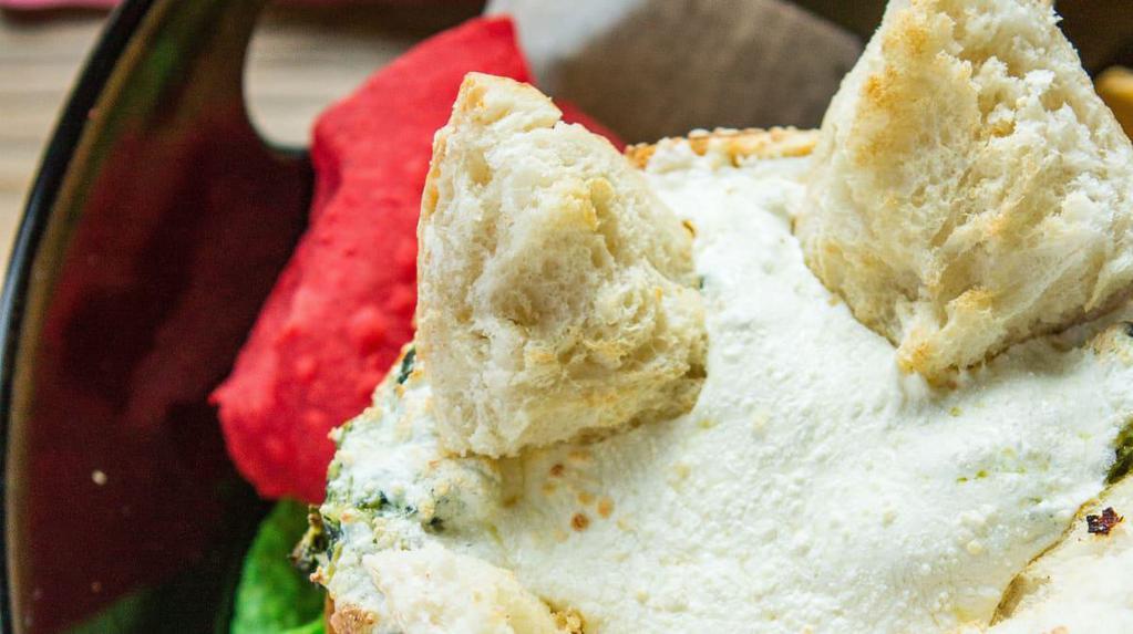 Sit-N-Spinach Dip · Oversized breadbowl filled with marinated artichoke hearts, spinach, and cream cheese blend.