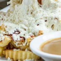 Disco Fries · Crinkle cut fries smothered in mozzarella cheese and served with a side of gravy.