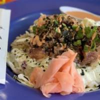 Poke Bowl · Traditional, Spicy or Teriyaki served on a beg of brown rice and coleslaw.