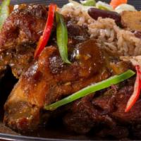 Brown Stew Chicken · Served with rice and peas or white rice and steamed vegetable or collard greens.