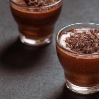 Chocolate Mousse · Smooth & Shiny melted chocolate dessert topped with whipped cream.