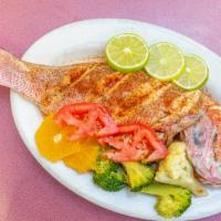 Steamed Whole Red Snapper · Seasoned with Old Bay garlic butter and served with your choice of side.