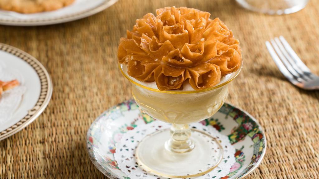 Banana Rum Pudding · Banana Pudding with Uncle Boons Rum topped with Whipped Cream, Caramelized Bananas & Thai Lotus Sesame Tuile.  (Gluten Free)