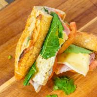 Paris Ham Sandwich · Ham, tomatoes, arugula, melted brie cheese, mayo and organic baguette bread.