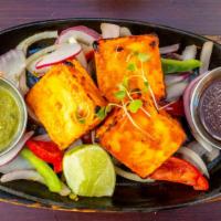 Paneer Tikkas · Marinated and barbecued soft artisanal cheese.