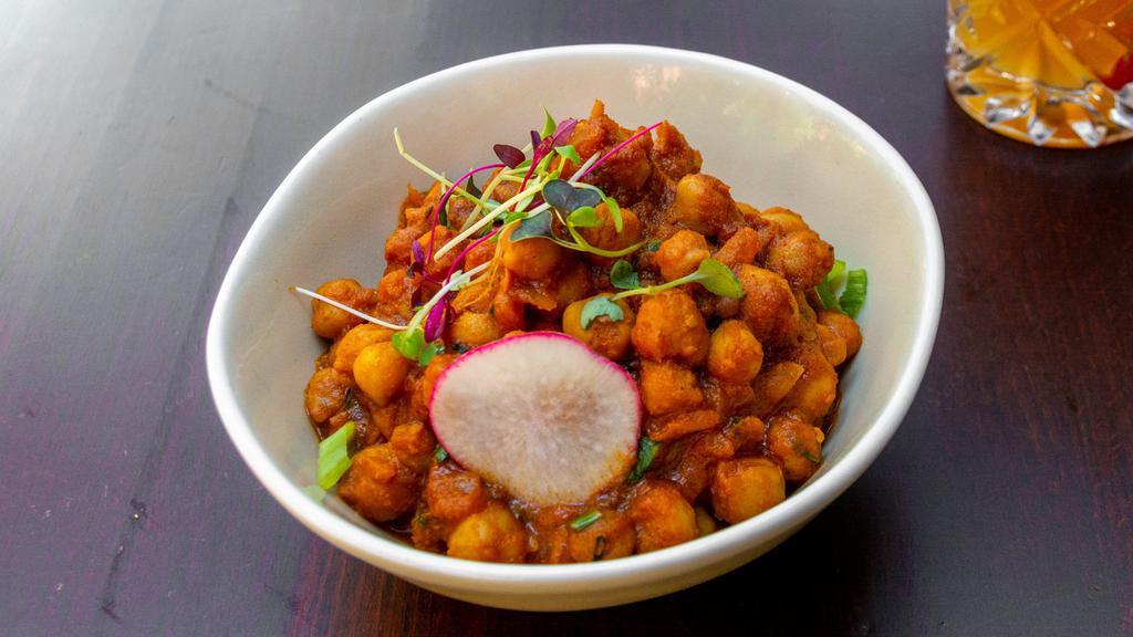 Chana Masala · An authentic north Indian-style chickpea curry made with white chickpeas, freshly powdered spices, onions, tomatoes and herbs.