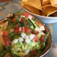 Classico Guacamole · Classic Guacamole with cilantro, jalapeño, tomato and onion. Fresh lime juice.  Served with ...