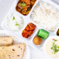Gujarati Thali · Two Vegetable curries, Rice, Dal/Kadki, one pc of sweet and pickle condiment.