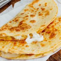 Queso Quesadilla · Served in a 8'' flour tortilla.