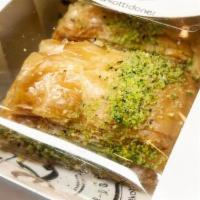 Baklava · Layers of filo filled with chopped nuts and bathed in mildly sweet honey finished w/ crumble...