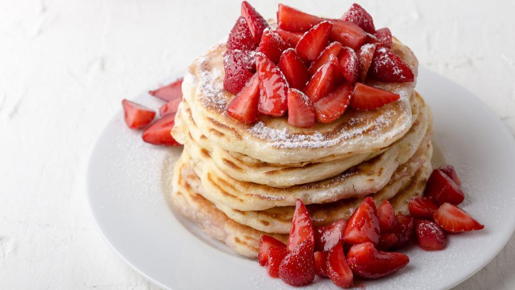 Strawberry Buttermilk Pancakes · 3 perfectly fluffy strawberry pancakes, served with a side of butter and syrup.