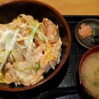 Katsu Don · Pork cutlet, onion, egg and sauce over rice.