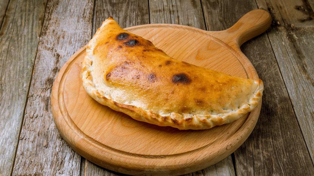 Spinach Calzone · Green, fresh spinach stuffed into a warm calzone.