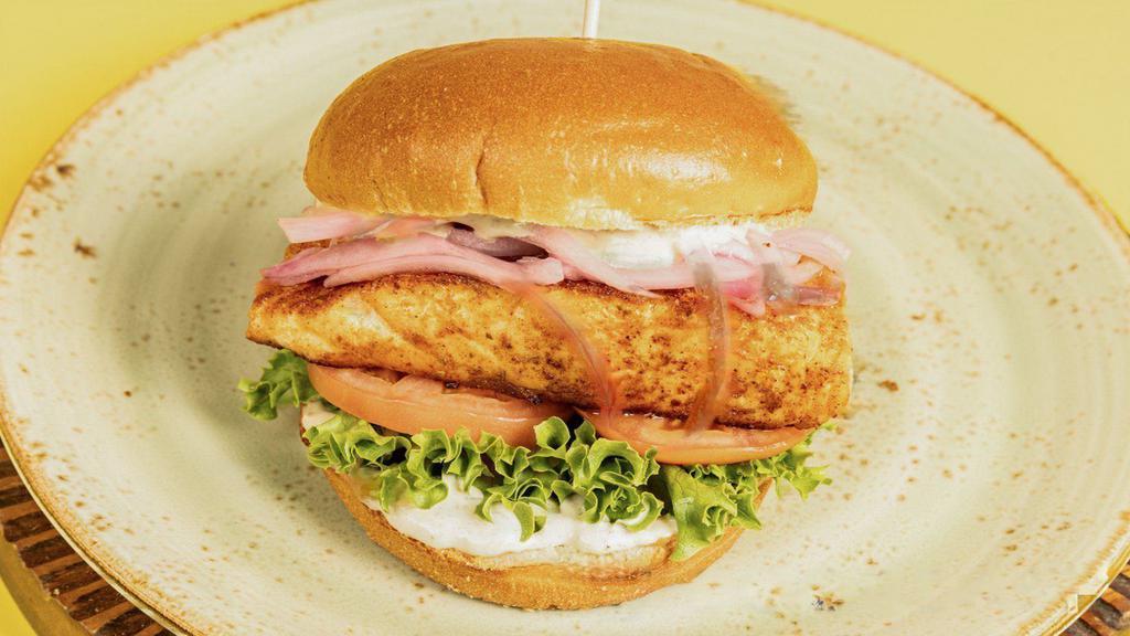 Cajun Grilled Salmon  · Grilled Salmon, lettuce, tomato, pickled onions, lemon capers mayonnaise, toasted brioche bun
