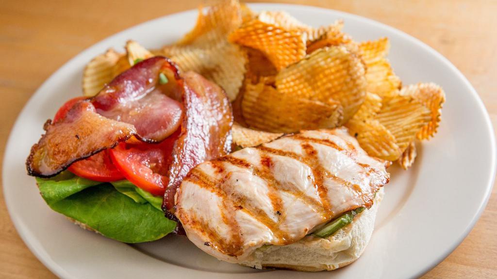 Grilled Chicken Club · Grilled free-range chicken cutlet, applewood smoked bacon, bibb lettuce, tomato, pickles, special sauce, on a toasted sesame bun, served with chips or crack kale.