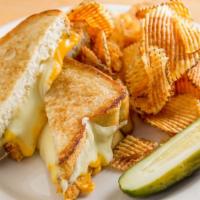 Grilled Cheese · Smoked gruyere, cheddar and American cheese on blue ribbon pullman bread, served with a pick...