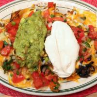 Super Nacho Macho · Black beans, guacamole, pico de gallo, sour cream, and cheese.