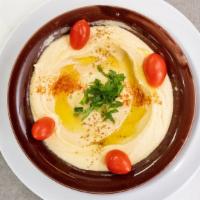 Hummus Appetizer {Vegetarian} · A mediterranean blend of chickpeas, tahini, fresh garlic and lemon juice topped with parsley...