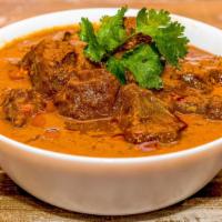 Lamb Rogan Josh · Cubes of lamb marinated in spices and cooked with chopped tomatoes in a creamy sauce.
