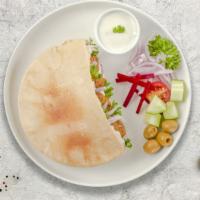 For The Falafel Pita · Falafel balls topped with lettuce, tomatoes, cucumber, hot and white sauce served in a pita ...